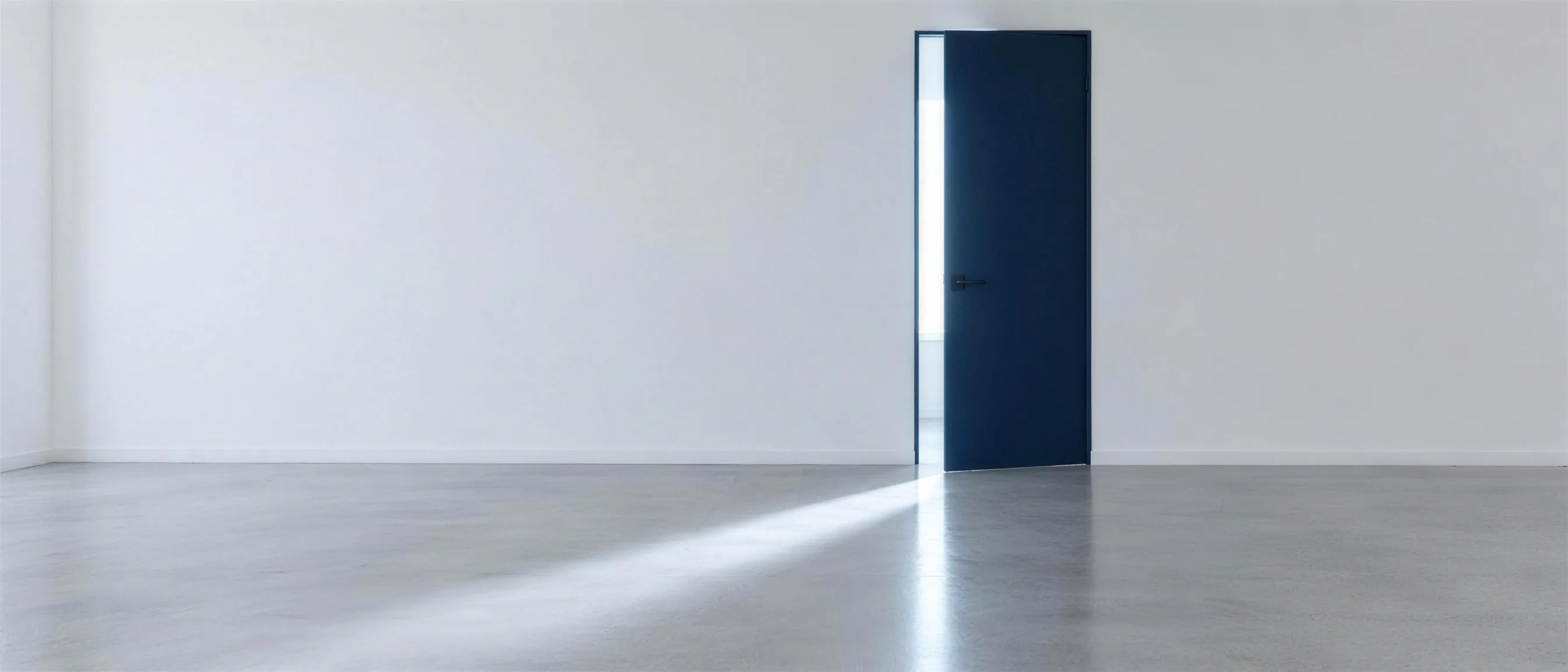 A dark blue door stands ajar in a bright room, daylight falling in onto the floor